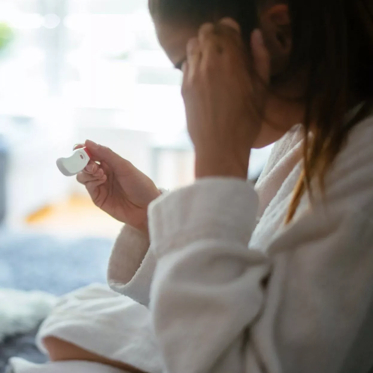 woman reading pregnancy test